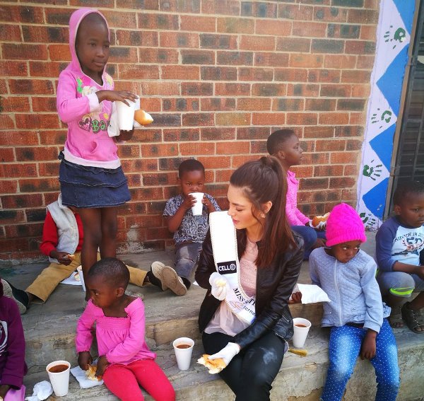 Miss SA Explains Why She Wore Gloves Whilst Dishing Out Food For Kids